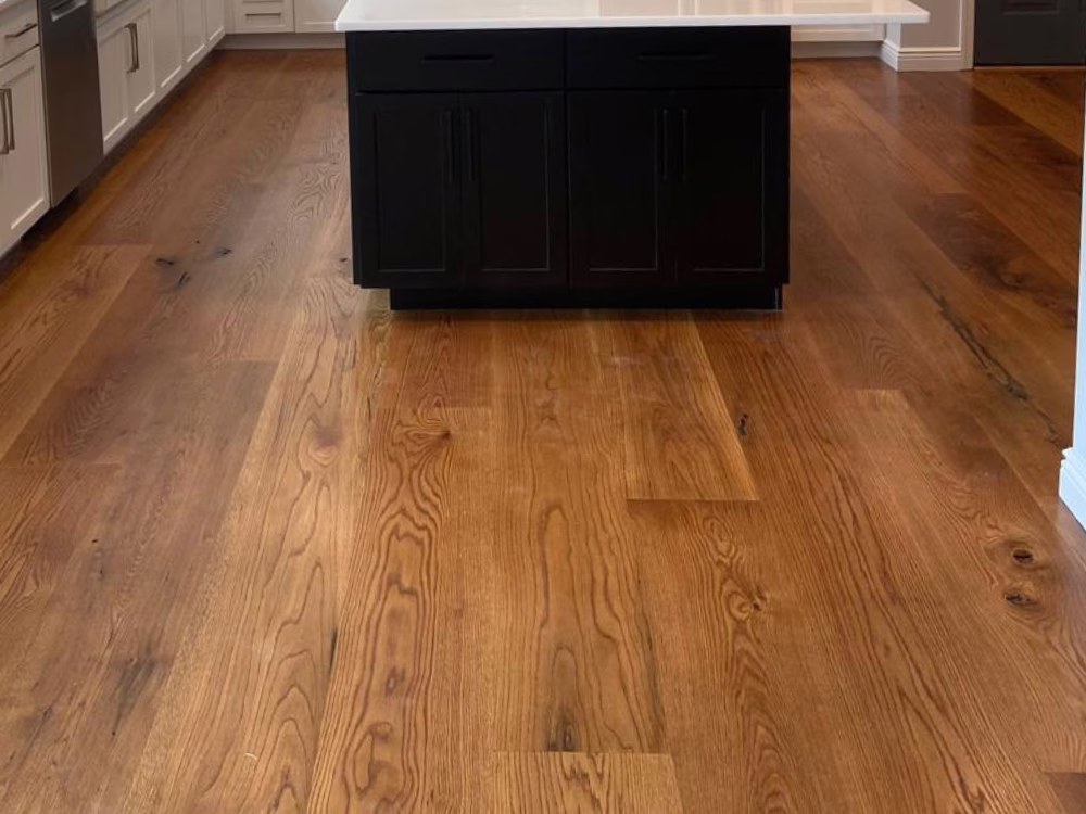 Hardwood flooring South Salem kitchen with wide-plank oak installation and professional finishing in a modern white and black interior.