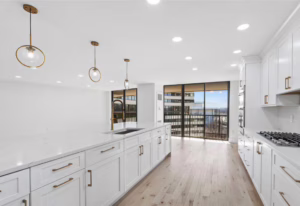 Kitchen Remodeling - Apartment with modern white cabinetry and sleek countertops.