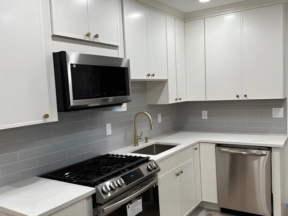 modern kitchen renovation with white cabinets and brass accents