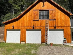 Barn painting project highlighting finished wood siding and upper window details